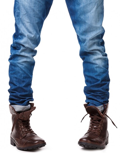 Male legs in jeans and leather boots