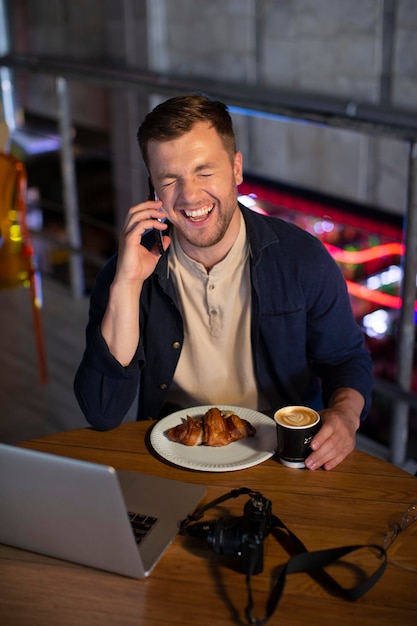 Male local traveler with a camera in a pub