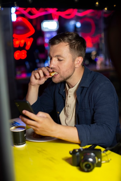 Male local traveler with a camera in a pub