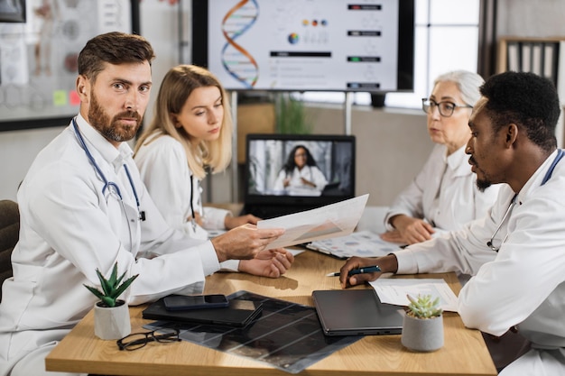 Male looking at camera with calm face in clinic meeting