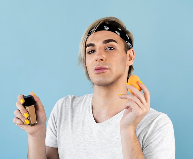 male make-up look holding foundation