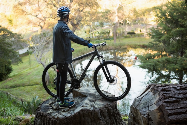 male man mountain biker with bicycle looking at nature