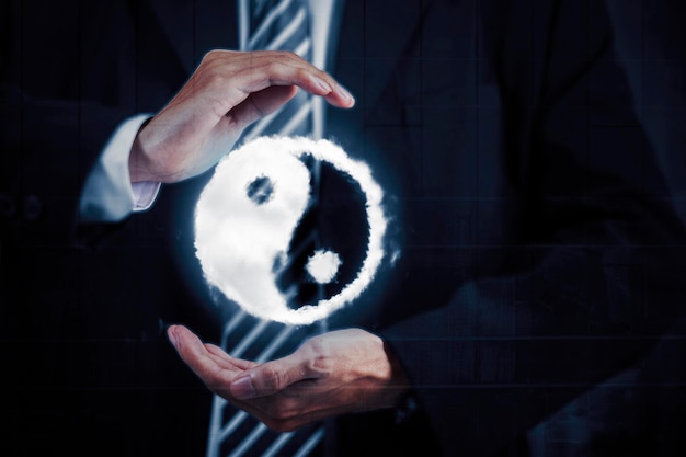 Male manager holding yin yang symbol