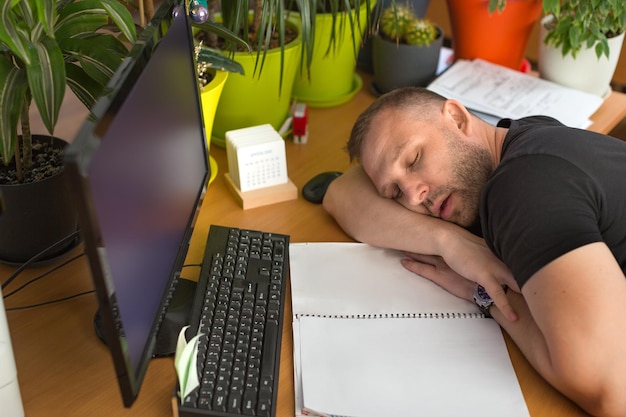 Male manager is sleeping in the workplace