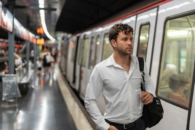 Male manager walking near train