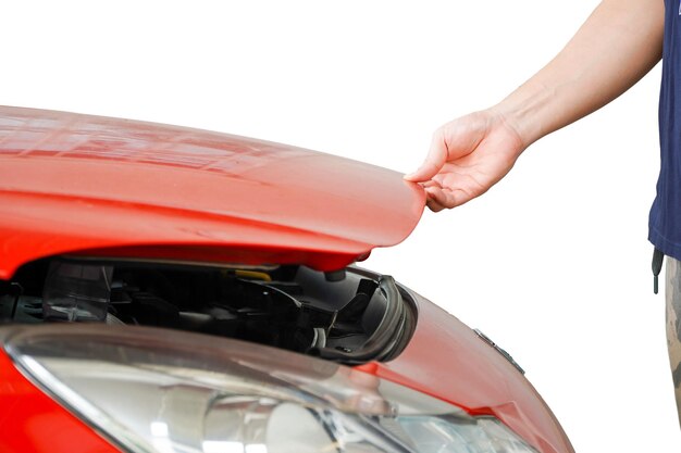 Male mechanic opens the hood of a car with his hand Checking car part and engine in automotive indus