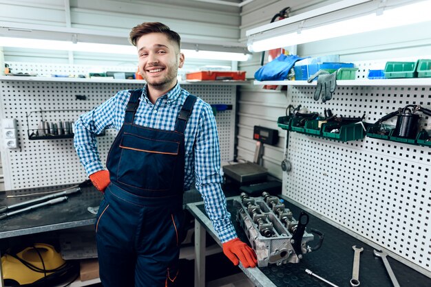 Male mechanic posing and smiling at camera.