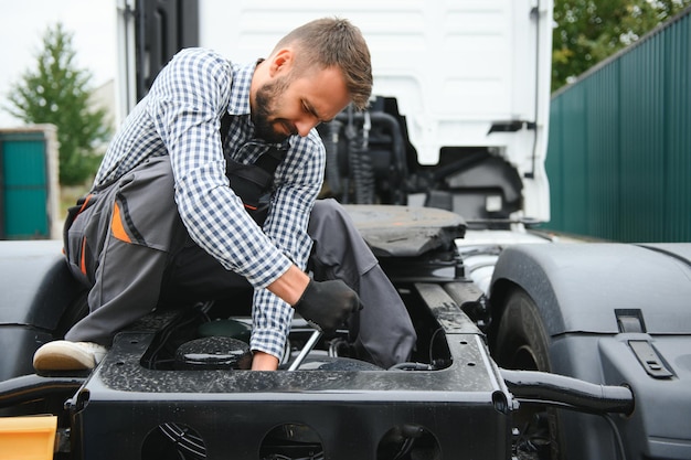 Male Mechanic repairing the truck