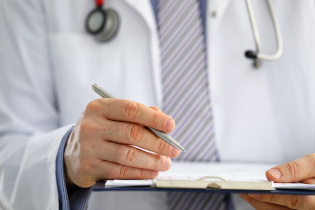 Male medicine doctor hand holding silver pen