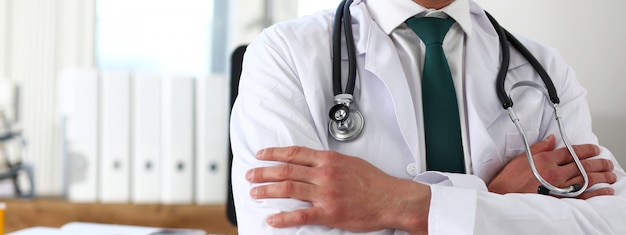 Male medicine doctor hands crossed on his chest in office