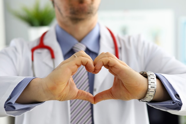 Male medicine doctor hands showing heart shape