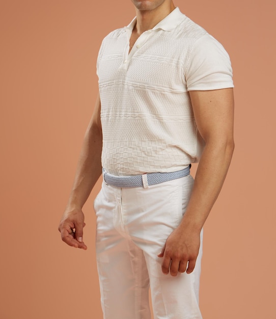 Male model with white shirt and trousers standing