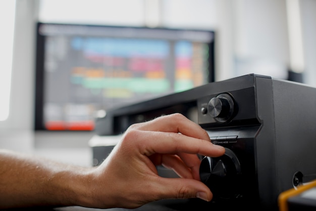 Male music arranger works with sound amplifier