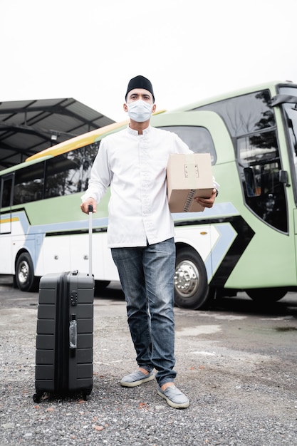 Male muslim travel by public bus during pandemic wearing mask