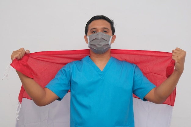 Male nurse holding indonesian flag