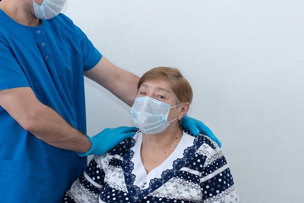 A male nurse with an elderly patient in the ward