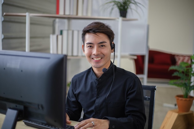 Male officer working and smiling in customer service\
office
