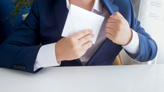 Male official taking bribe in envelope and putting it in jacket