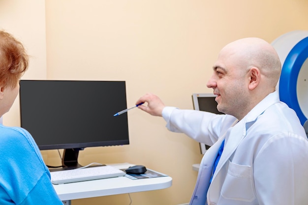 A male ophthalmologist explains the results of an eye examination to an adult woman showing