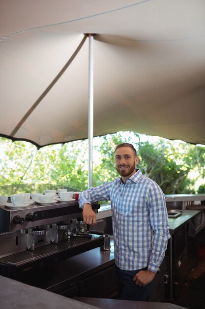 Male owner standing at outdoor cafÃ©