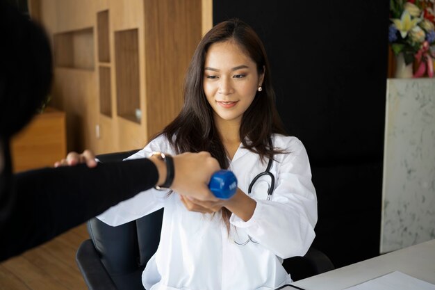 Male patient doing physical exercises with his physiotherapist.