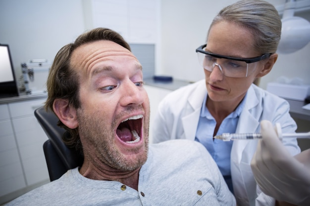 Photo male patient scared during a dental check-up