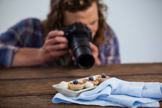 Male photographer photographing food