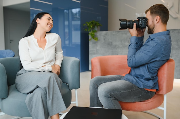 Male photographer taking picture of young woman