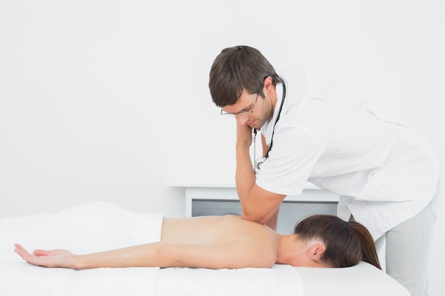 Male physiotherapist massaging womans back