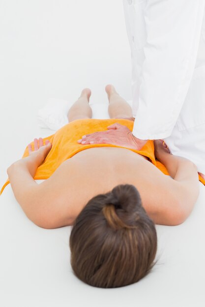 Male physiotherapist massaging womans back