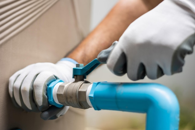 Male plumber worker installation pipe system hand holding the\
water tap faucet plumbing checking service and repair