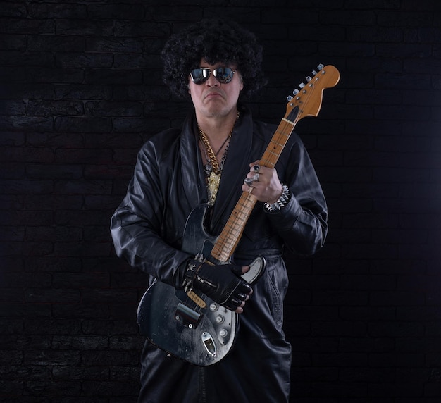 male portrait of heavy metal rock musician with electric guitar