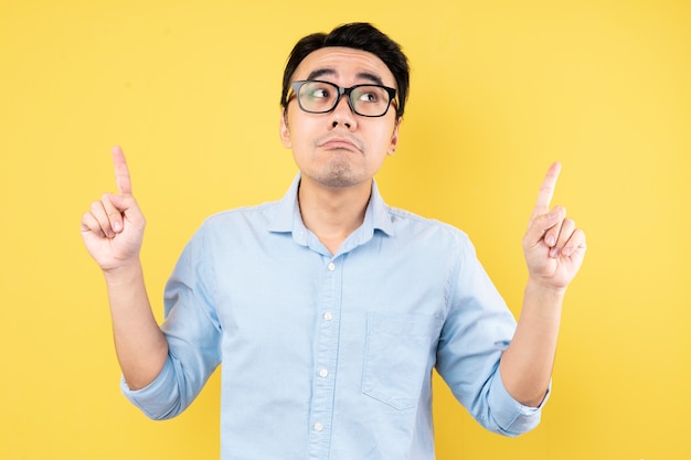 Male portrait wearing shirt, isolated on yellow background