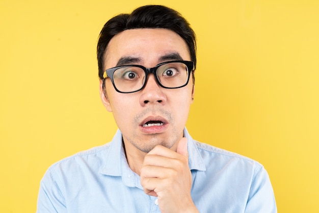 Male portrait wearing shirt, isolated on yellow background