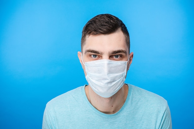 Male posing with surgical mask on face in studio