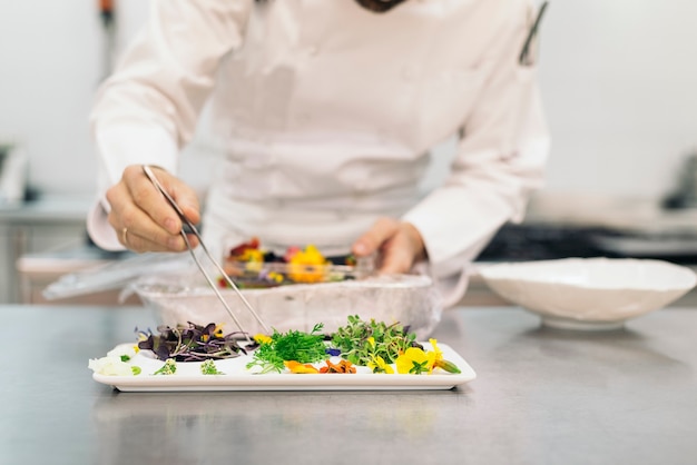 Male professional chef cooking in a kitchen.