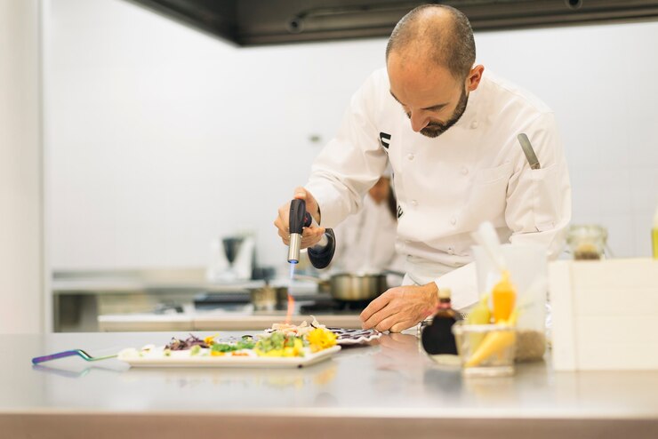 Photo male professional chef cooking in a kitchen.