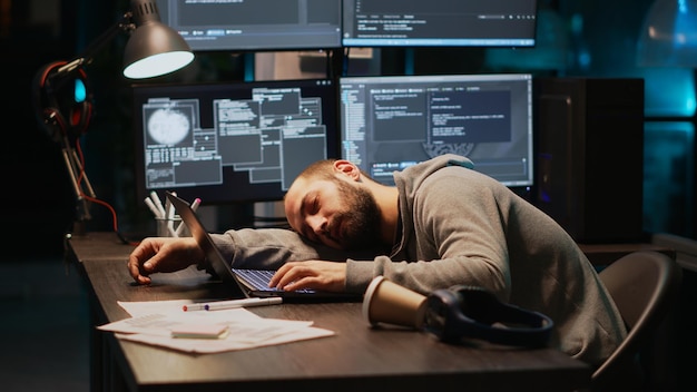 Male programmer falling asleep on office desk, feeling tired\
and trying to work on database server. exhausted web developer\
being sleepy and yawning late at night, cloud computing.