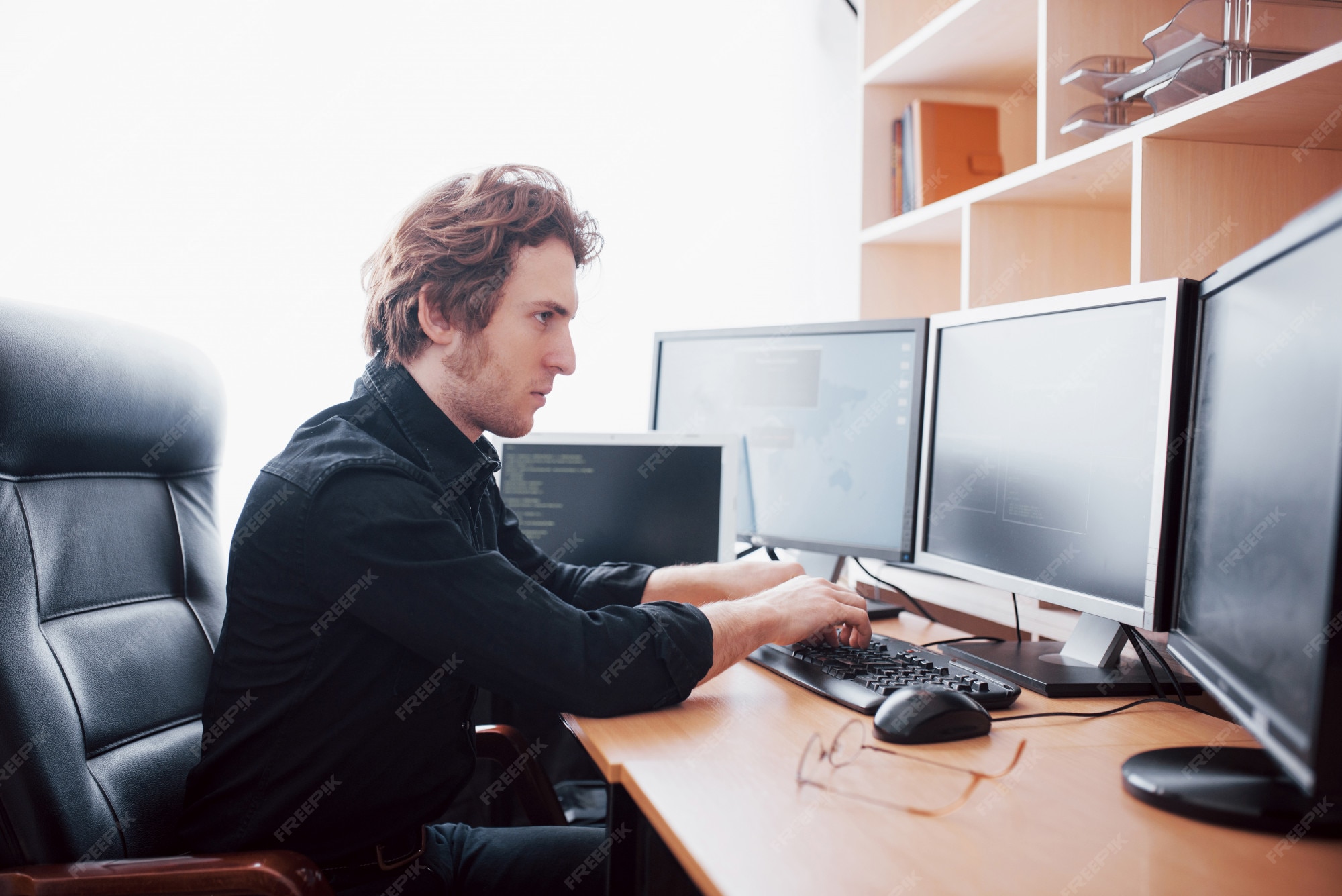 Premium Photo | Male programmer working on desktop computer with many ...