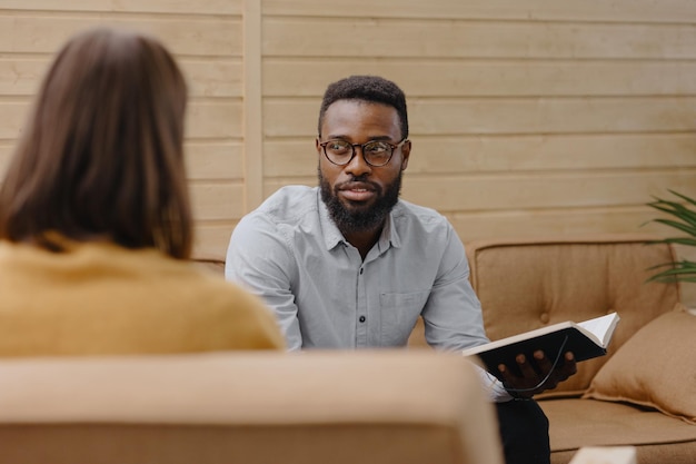 Male psychologist conducts a patients appointment in an office or a medical center african american