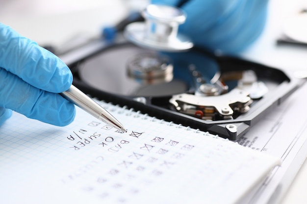 A male repairman wearing blue gloves