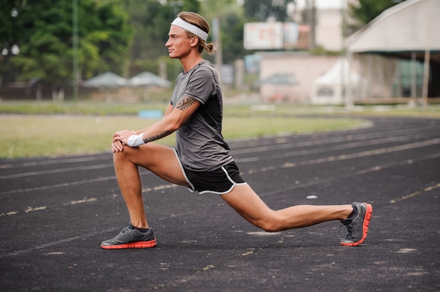 Male runner stretching before workout