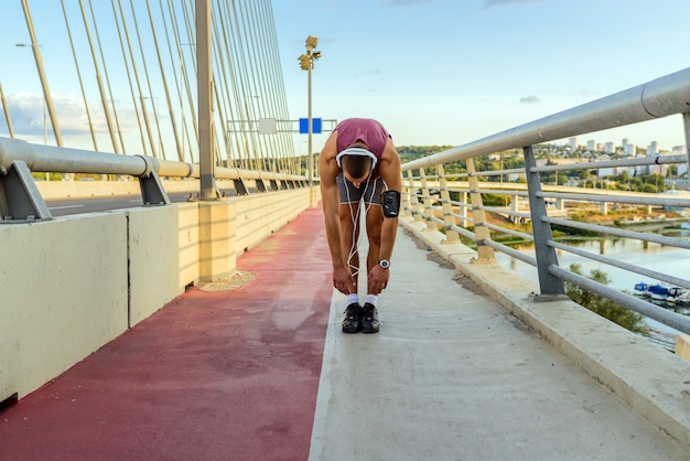 Male runner stretching his legs.