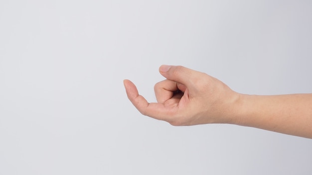 Male's left hand doing beckon sign on white background.