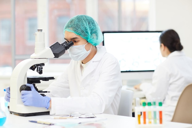 Male scientist analyzing test sample in laboratory