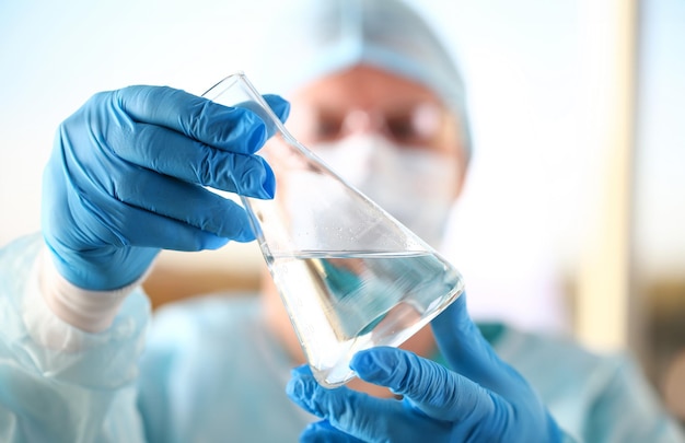 Male scientist hold in arm empty vials closeup