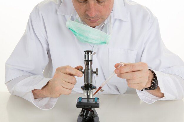 Male scientist using microscope in laboratory