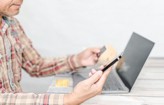 Male shoppers holding smartphones and very happy Concept for mobile laptop phone casual smartphone shopping smile happiness payment Copy space upper side Selective focus Blurred background