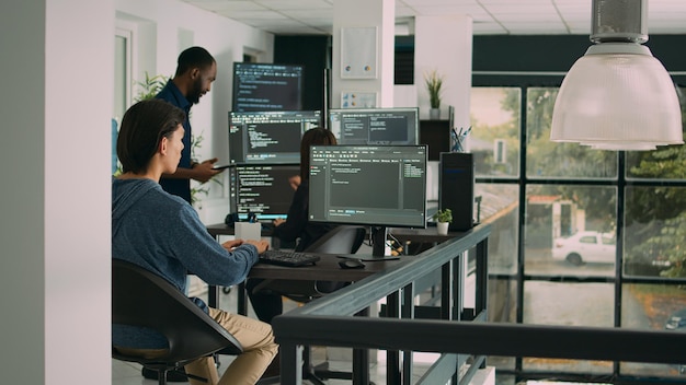 Male software developer typing machine learning app code on computer, sitting at desk in big data office. Cloud programer working on database system with html script in it security agency.