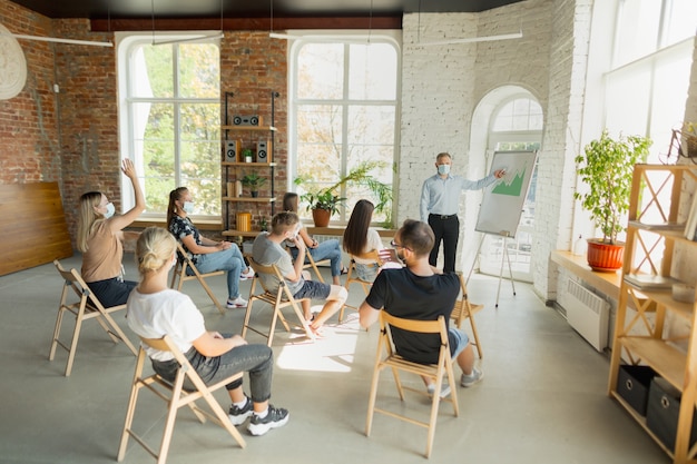 Male speaker giving presentation in hall at university workshop Audience or conference hall